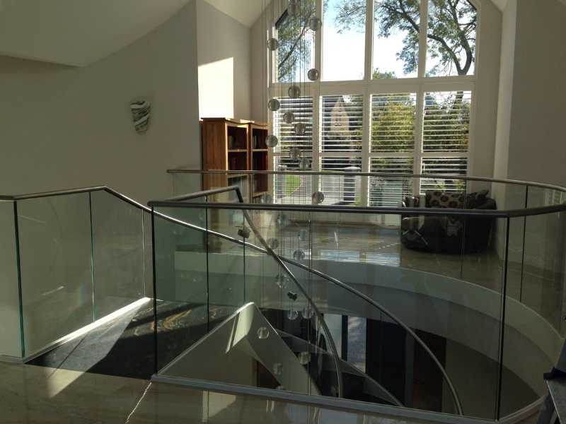Bespoke lower-half shutters on a large gable-end window in Beaconsfield