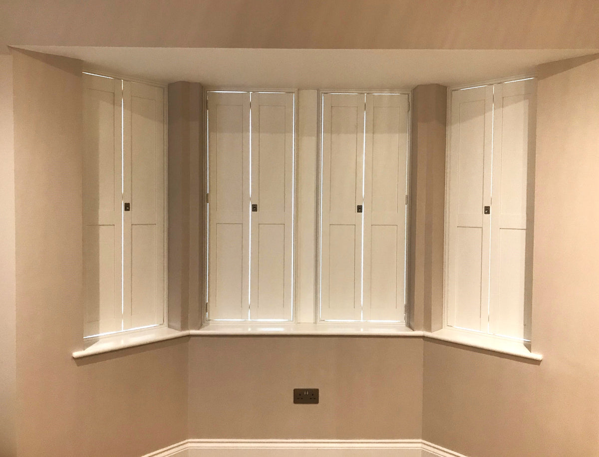 Solid panel shutters installed in a Buckinghamshire bay window