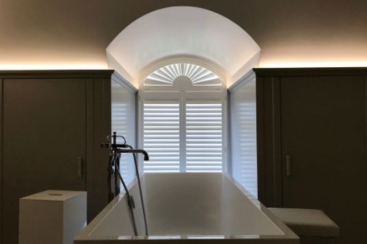 Shaped Window Shutters in a considered interior