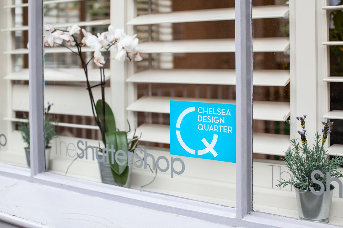 The Shutter Shop Fulham showroom window displaying the Chelsea Design Quarter sign