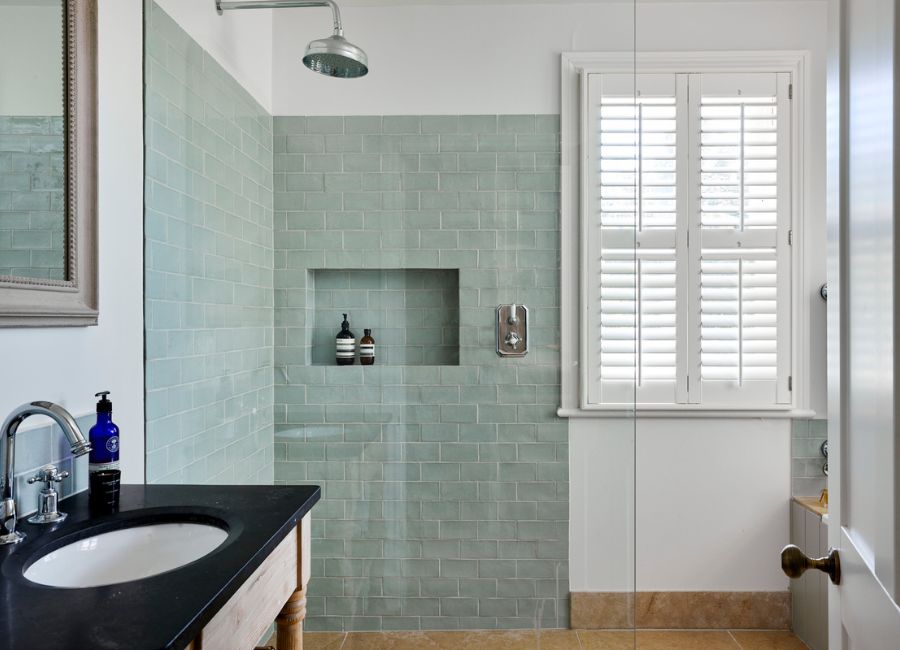 Tier on tier shutters in a bathroom with a shower